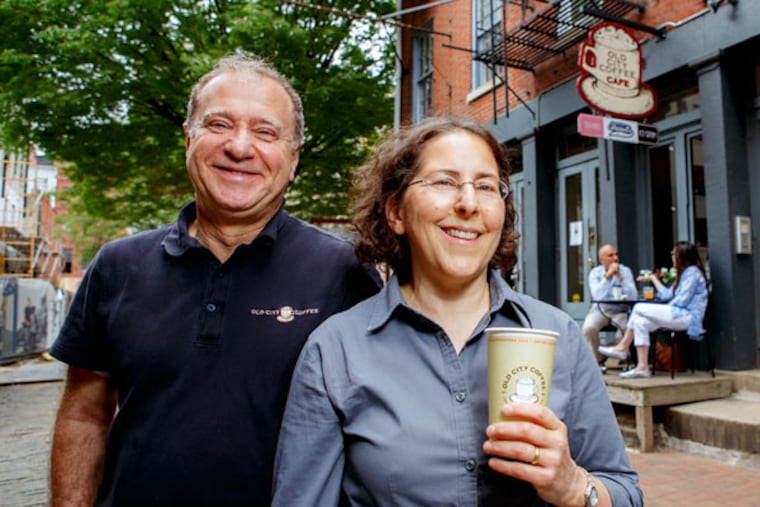Old City Coffee owners Jack Treatman and Ruth Isaac outside the shop on Church Street. The business, started by Isaac in 1985, also has two outlets in the Reading Terminal Market. (JEFF FUSCO/For The Inquirer)