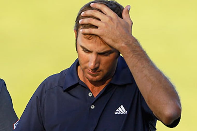 Zach Johnson was assessed a two-stroke penalty for grounding his club in a bunker on the 18th hole. (Charlie Neibergall/AP)