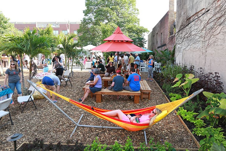 Jordan Price relaxes at the Pop Up Garden at 1438 South St. Tuesday, July 8, 2014. Proceeds from the Pop Up Garden support PHS City Harvest, which creates green jobs and brings together a network of community gardeners, who grow fresh, healthy produce for families in need.