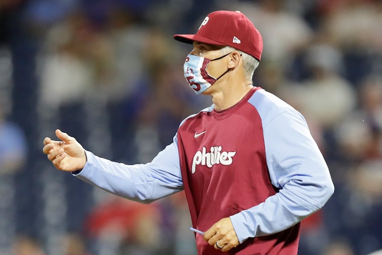 Phillies manager Joe Girardi reaching for the baseball during a pitching change in a May 20 game against the Miami Marlins at Citizens Bank Park.