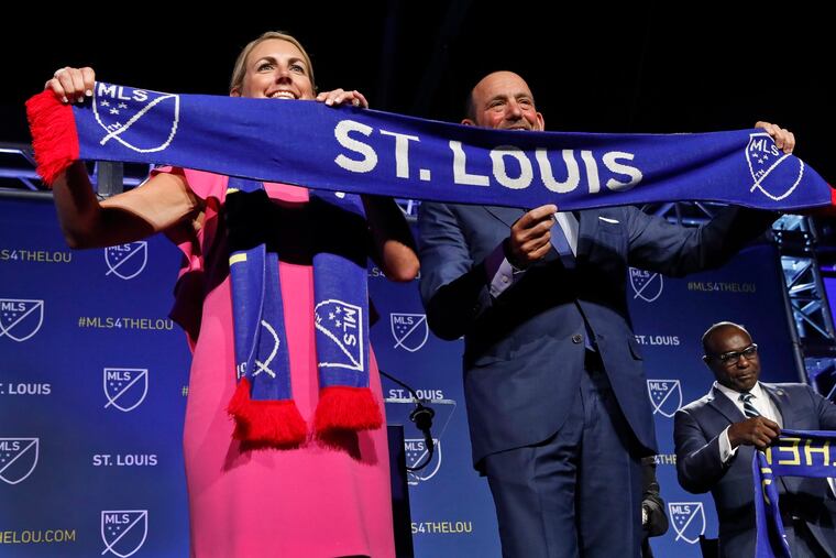 Carolyn Kindle Betz (left), a member of the ownership group of the new soccer franchise, and Major League Soccer Commissioner Don Garber display a St. Louis soccer scarf after the announcement Tuesday that MLS has awarded the next expansion franchise to St. Louis, where a new downtown stadium will be built and the team will begin play during the 2022 season.