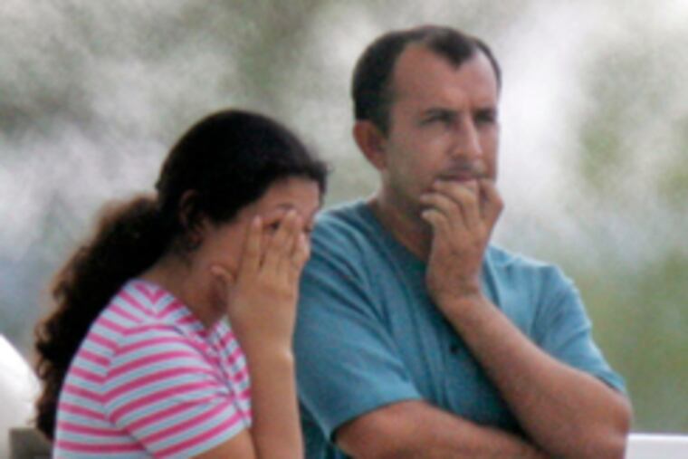 Two people hug in an area for families of the six trapped miners. Rescue tunneling was suspended indefinitely after a second collapse.