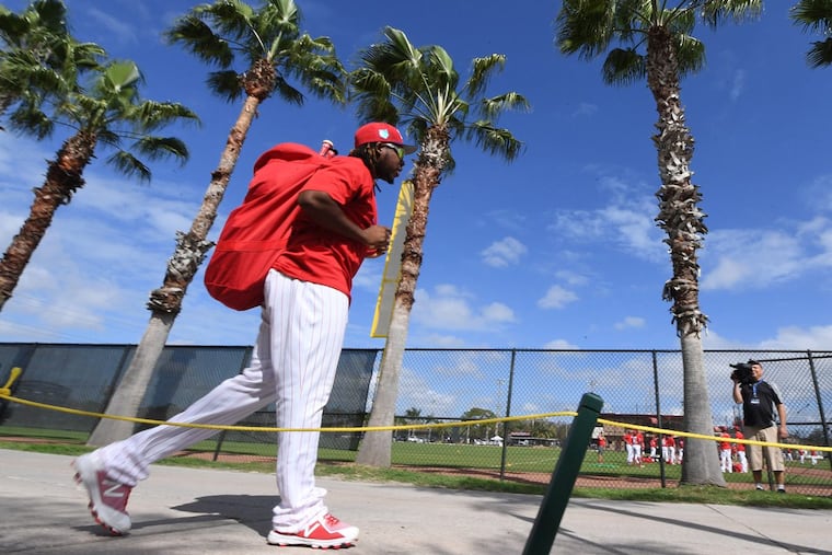 The Phillies’ Maikel Franco walks to the field for spring training workouts in Clearwater.