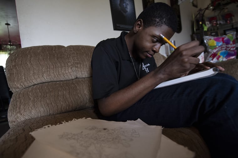 Andrew Cambridge, draws at his home in Willow Grove Pa. Monday, Sept 17, 2018. Andrew, exposed to alcohol in the womb, has been with the Cambridges since he was 6 months old. He is child-like with autism (or autism-like behavior). Andrew loves drawing and cartooning. JOSE F. MORENO / Staff Photographer .