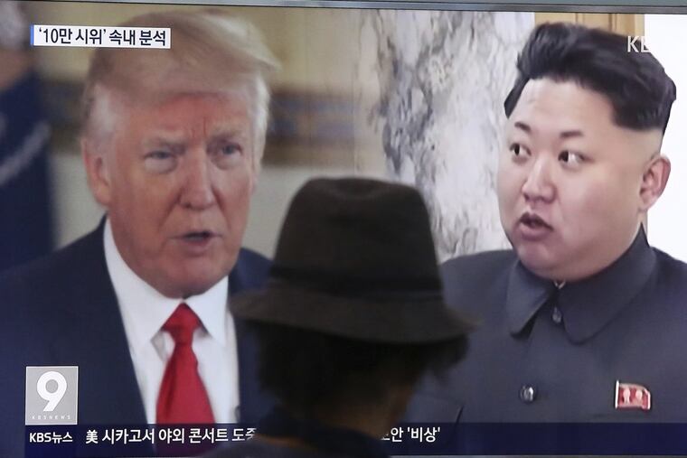 A man watches a television screen showing President Donald Trump and North Korean leader Kim Jong Un during a news program at the Seoul Train Station in Seoul, South Korea, Thursday, Aug. 10, 2017. (AP Photo/Ahn Young-joon)