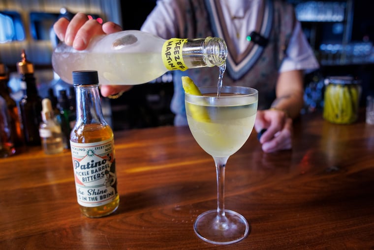 Resa Mueller, bartender pouring a Freeze Martini at R & D Cocktails, Frankford Avenue, Fishtown section Philadelphia on Thursday, October 31, 2024. She is making cocktails for coping with election.