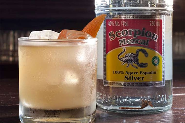 El Escorpión cocktail and bottle of Scorpion Mezcal Silver at Pub & Kitchen. (David M Warren/Staff Photographer)