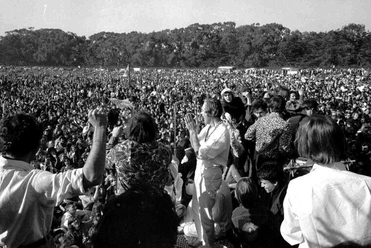 Timothy Leary, center, leads thousands in a song at the “Human Be-In” On the Golden Gate Park Polo Fields in San Francisco in 1967.
