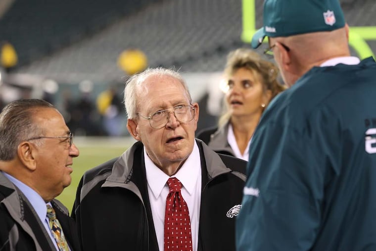 Jim Solano (left) alongside former Eagles coach Buddy Ryan (center) in 2011 when Ryan was honored by team. Solano was Ryan's agent.