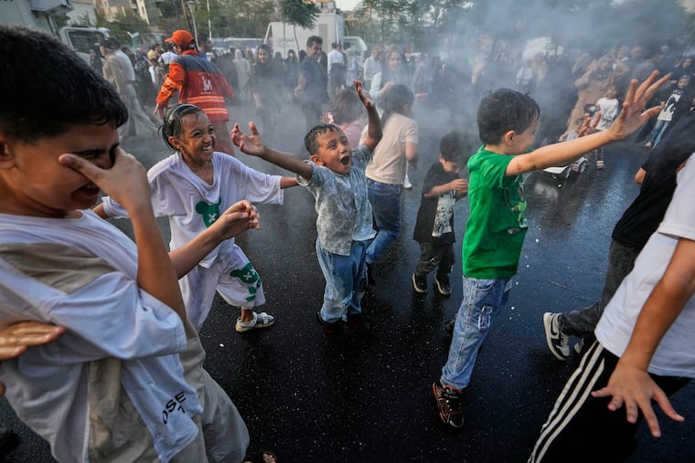 Children laugh and play in a spray of water during a street celebration marking Prophet Muhammad's birthday in Tehran, Iran, Sunday, Aug. 30, 2026.