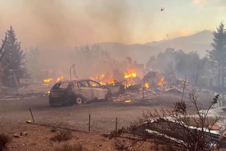 This image taken from video shows a charred neighborhood following wildfires Saturday, Aug. 22, 2026, in Reno, Nevada.