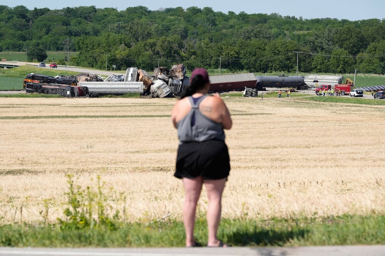 A woman records on a phone after a train derailed in June, near Victor, Iowa. Technology has transformed how we experience emergencies. Smartphones allow anyone to become an eyewitness, and social media rewards immediacy, write Kristi Hughes and Michael L. Saile Jr.