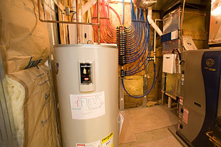 A Dewey Homes house in the Ravens Claw Golf Club community complete with tankless water heater, geo thermal heating, and sealed ductwork. (Ed Hille / Staff Photographer)