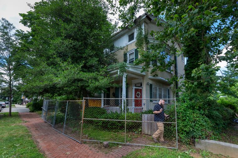 An official with Philadelphia Department of Licenses & Inspection leaves the property after placing stop work sticker on window at Pearson House, 5139 Wayne Ave. The home is listed on the Philadelphia Register of Historic Places.
