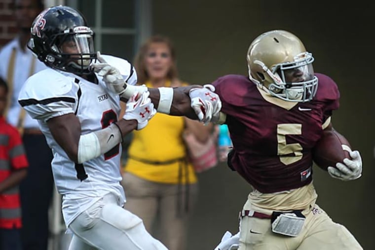 Haverford School's Phil Poquie en route to an 88-yard touchdown run against Ryan's Seneca William. (Steven M. Falk/Staff Photographer)