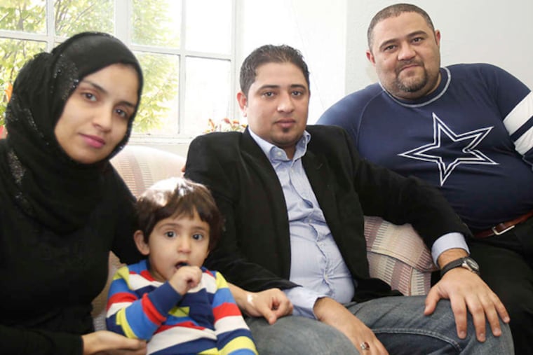 Hamza Albahadly (second from right), his brother Hussein (right), and Hamza's wife and son. The brothers worked with U.S. forces in Iraq before being forced to leave and settling here. (AKIRA SUWA / Staff Photographer)