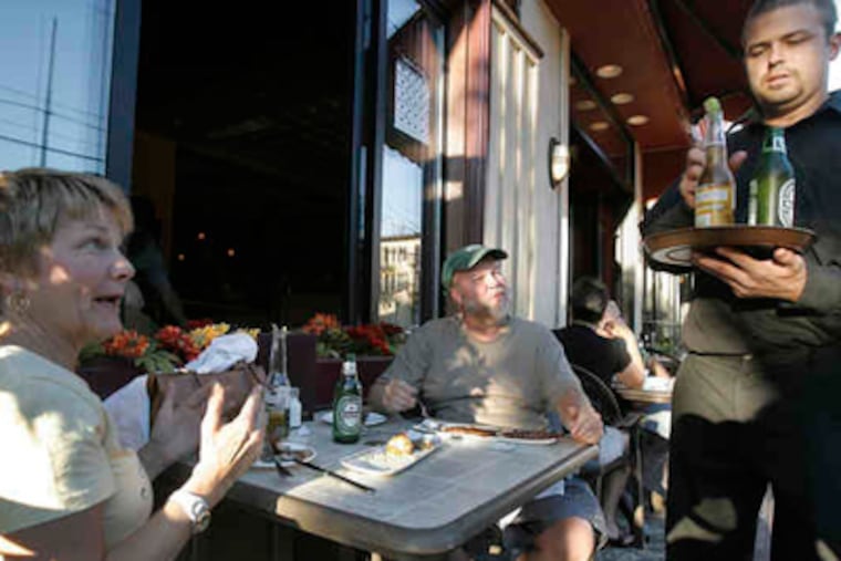 Victoria and Tim Fanning of Swarthmore get their drinks from a waiter at Stephen's on State, which opened in 2003. (Akira Suwa / Staff Photographer)