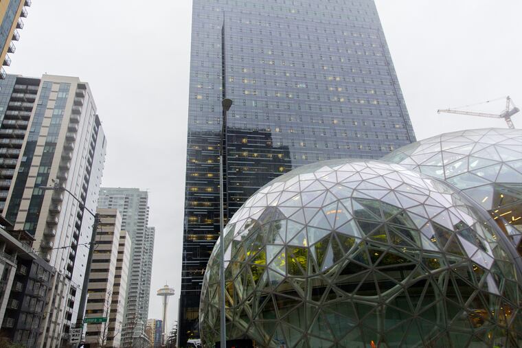 The Seattle Space Needle is seen past the Amazon.com Inc. Spheres in Seattle.