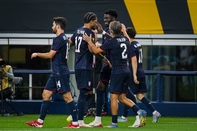 Patrick Agyemang (rear) is congratulated by teammates after his goal.