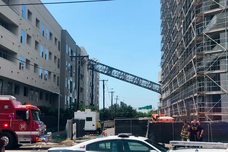 This photo taken and provided by Michael Santana shows a construction crane toppling on an apartment building as it was buffeted by high winds during a storm in Dallas, Texas, Sunday, June 9, 2019.