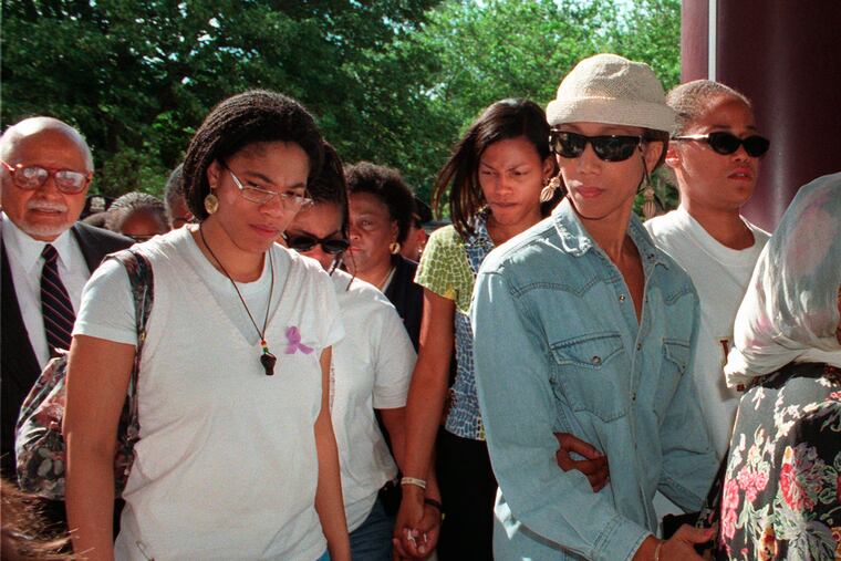 Malikah Shabazz (left), daughter of Malcolm X, shown walking with her sisters Ilyasah (third from right), Attallah (second from right), and Malaak after talking to the media following the death of their mother, Betty Shabazz, in June 1997.