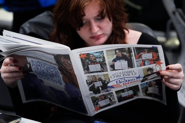 FILE - Columbia College Chicago student Kailey Ryan reads a newspaper in Chicago, Nov. 5, 2024.
