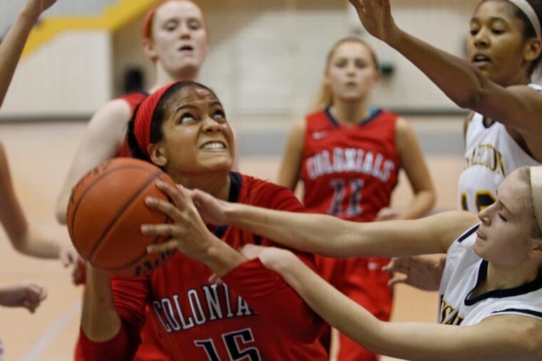 Plymouth Whitemarsh's Asia Baker, #15, center, fights to get off a shot after a rebound against Wissahickon's #4, Shannon Stagliano during Friday's game. Plymouth Whitemearsh vs Wissahickon girls basketball. Girls' basketball feature/notes. On Plymouth Whitemarsh's Asia Baker, a transfer from Shipley. 12/20/2013 ( MICHAEL BRYANT / Staff Photographer )