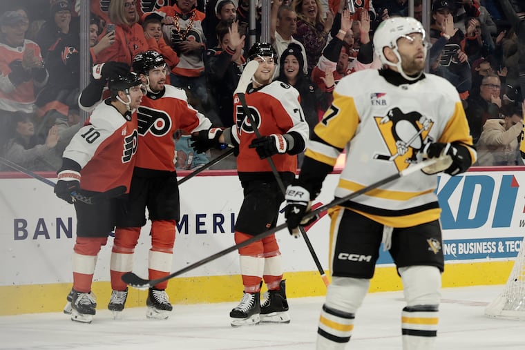 Flyers (from left) Bobby Brink, Noah Cates, and Tyson Forester react after a goal against the Penguins earlier this season. Can Philly upset the Pens in the first round?