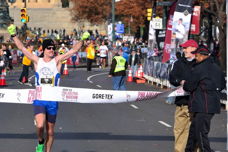 Dan Vassallo, 29, was the first marathon runner to cross the finish line on Sunday at the Philadelphia Marathon. (C.F. Sanchez / Staff Photographer)