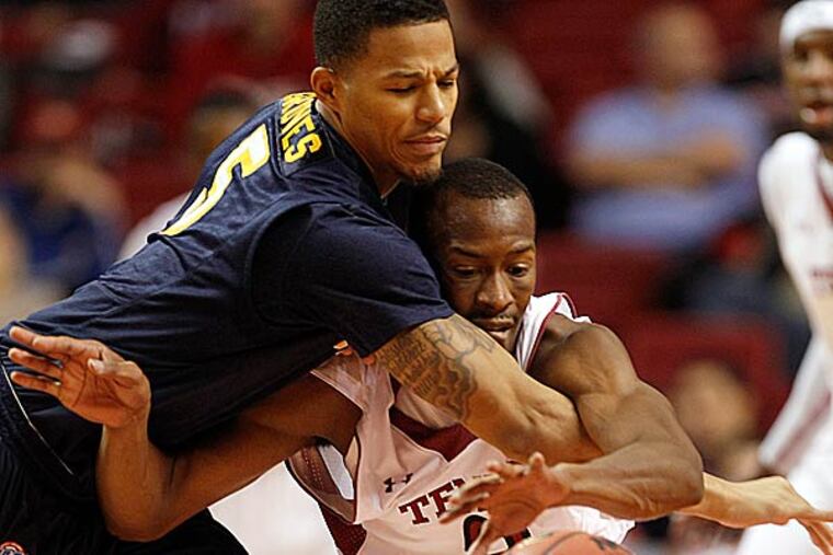 Temple's Will Cummings gets fouled going after a loose ball against Canisius' Reggie Groves. (Yong Kim/Staff Photographer)