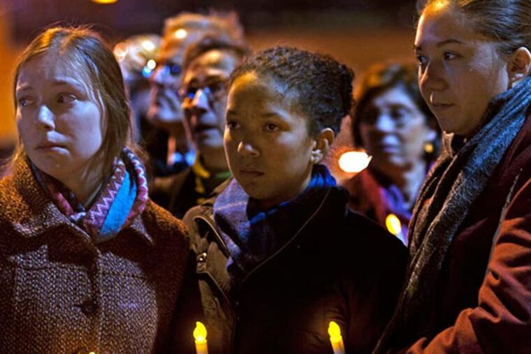 Three friends of Anne Bryan, who was killed in the collapse, from left to right: Zoe Zurad; Carla Dudley; and Sara Pottenger. Ministers and grieving loved ones hold sermon, march and vigil to mark 6-month anniversary of the fatal Market Street building collapse in June on Dec. 4, 2013. ( APRIL SAUL / Staff )
