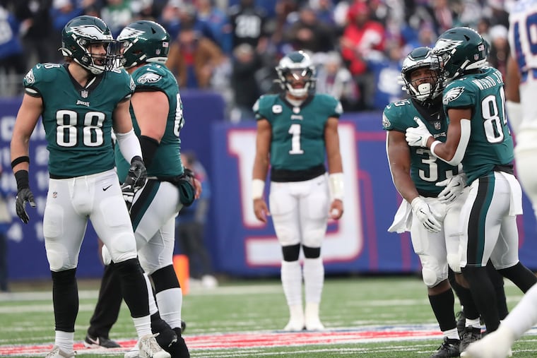 Eagles running back Boston Scott (second from the right) after his fumble killed a potential game-winning drive on Sunday.