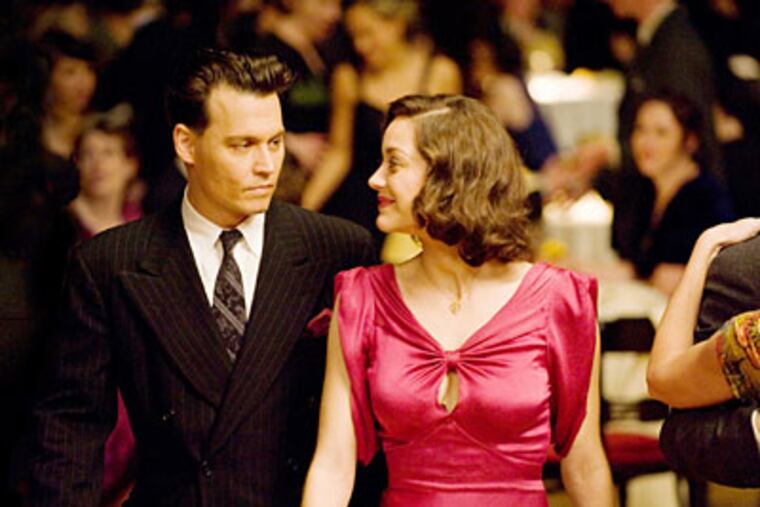 Johnny Depp stars and Marion Cotillard star in "Public Enemies."