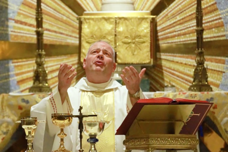 The Rev. Joseph Okonski celebrates Mass at St. Athanasius Church in West Oak Lane. (Michael Bryant / Staff Photographer)