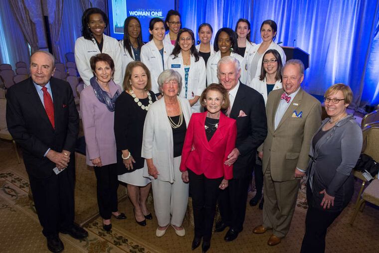 Woman One scholars stand behind (front, from left) D. Walter Cohen, Dianne Semingson, Constance Williams, Lynn Yeakel, Lynne Honickman, Harold Honickman, Daniel Schidlow, and Shira Goodman.