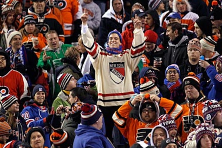 A Rangers fan celebrates a New York goal in the middle of Flyers fans at the Winter Classic. (Yong Kim/Staff Photographer)