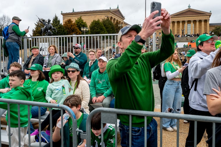 Ryan Walsh records his niece performing with the McDade-Cara School of Irish Dance in Newtown Square during the annual Philadelphia St. Patrick's Day Parade on Mar. 16, 2025.