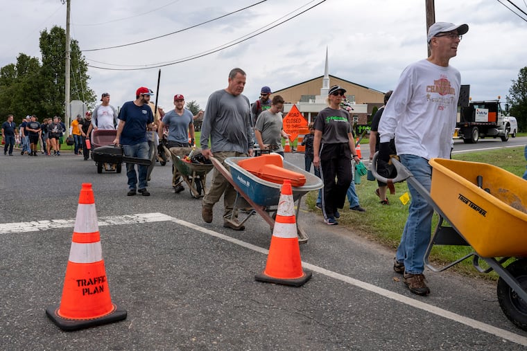 Members and volunteers with Fellowship Bible Church head out to help clean up property of neighbors in 2021, following the destruction from a tornado spawned by the remnants of Hurricane Ida.