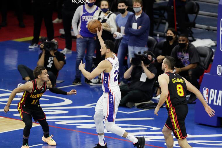 Sixers guard Ben Simmons passes the basketball against Atlanta Hawks guard Trae Young and forward Danilo Gallinari during the fourth quarter in Game 7 of the NBA Eastern Conference playoff semifinals on Sunday, June 20, 2021 in Philadelphia.
