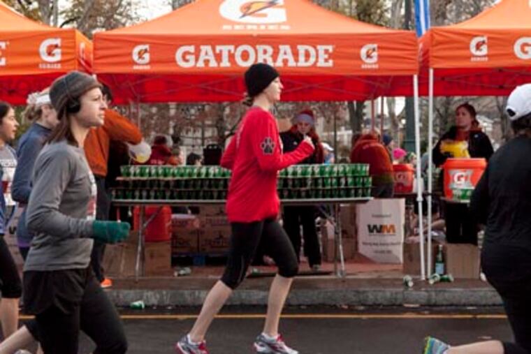 Volunteers prepare approximately 600,000 compostable cups of water for runners at the 2012 Philadelphia Marathon. (Hillary Petrozziello/Philly.com)