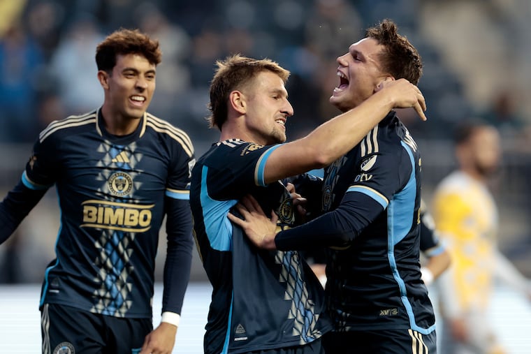 Bruno Damiani (center) celebrates with teammates after scoring the Union's opening goal.