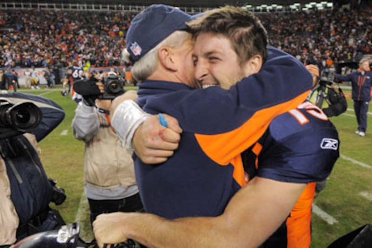 Denver Broncos quarterback Tim Tebow (15) hugs coach John Fox after winning 30-23 against the Pittsburgh Steelers in overtime of an NFL wild card playoff football game Sunday, Jan. 8, 2012, in Denver. (AP Photo/Jack Dempsey)