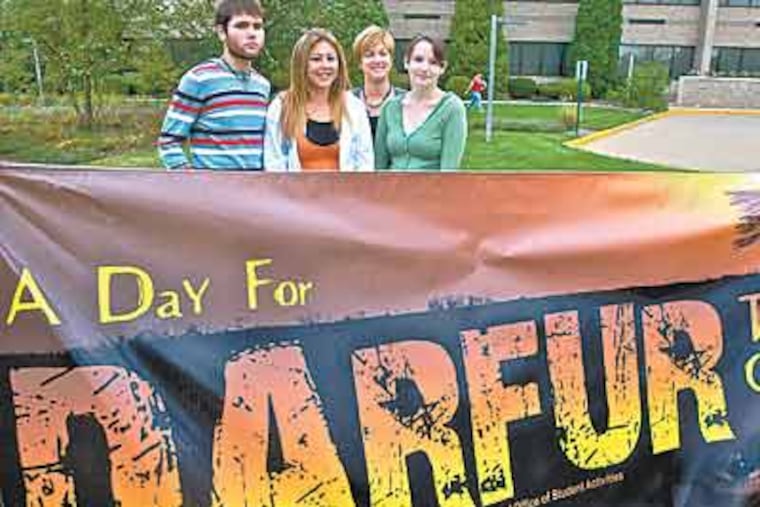 Burlington County College students Sean Parsons, Laura Dyer and Liz Lofton with associate dean Cathy Biggs (rear) prepare for Darfur-awareness events on campus.