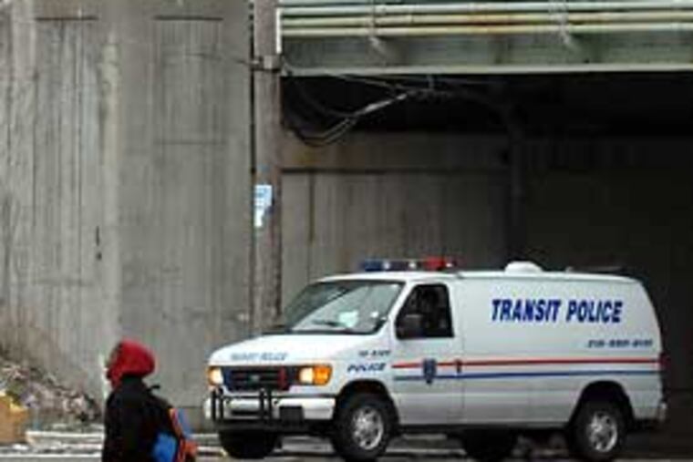 An R-3 train passes slowly Tuesday as SEPTA officials investigate the scene of pre-dawn collision between a SEPTA work train and a commuter train. (Tom Gralish / Staff Photographer)