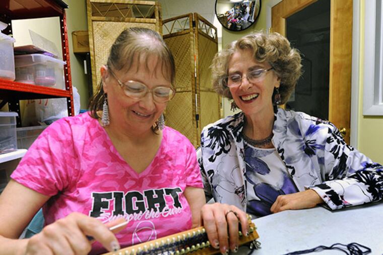 At Jubili Beads & Yarns in Collingswood, owner Judith Weinstein (right) helps Patti Linthicum with a project, on Oct. 10, 2013. Weinstein not only sells beads and craft supplies, but teaches classes but teaches to special-needs customers.( APRIL SAUL / Staff )