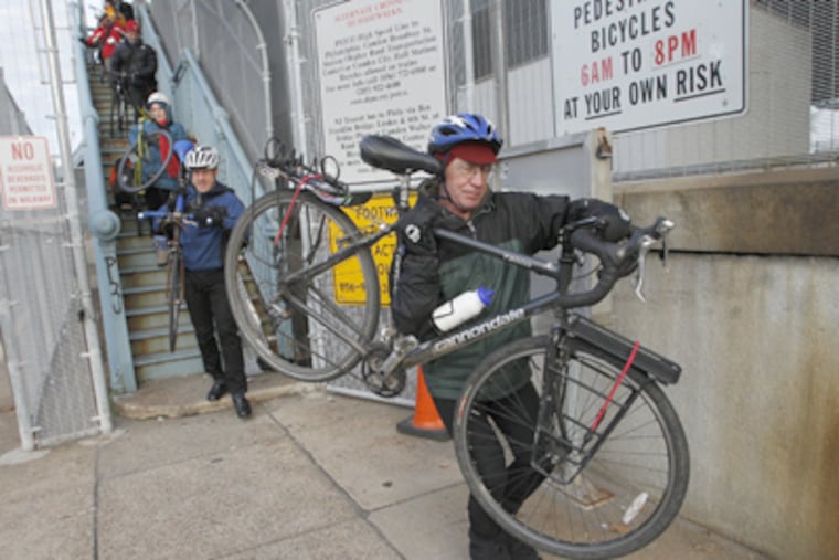 Timothy Carey and other members of the Bicycle Coalition of Greater Philadelphia make their way down the stairs on the Camden side of the Ben Franklin Bridge. (Alejandro A. Alvarez / Staff Photographer)