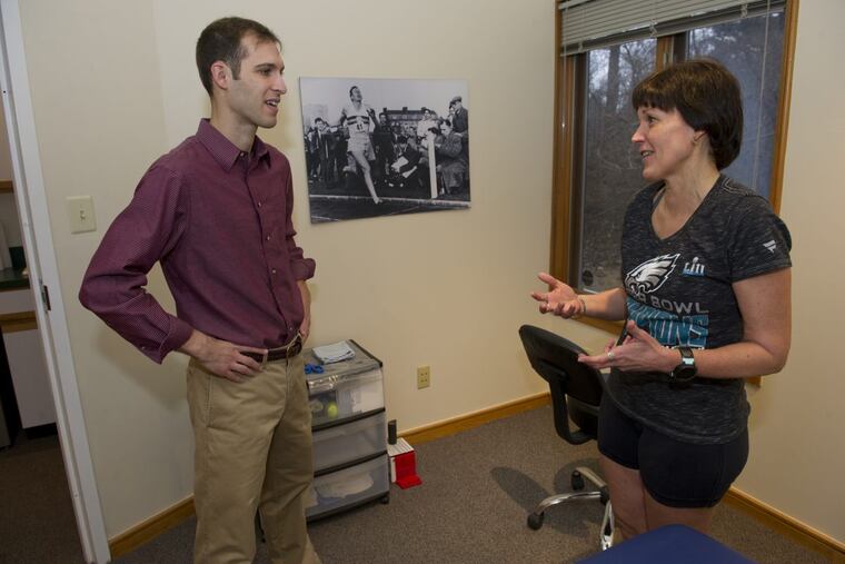 Flash Sports Physical Therapy and Performance Center physician Dr. J. Ryan Bair speaks with patient Marianne Bowman, 54, in his West Chester office on February 16, 2018. Flash is a cash-only physical therapy practice, so patients know up front what their cost will be and can bill their insurance later.