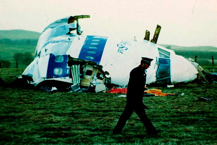A police officer walking by the nose of Pan Am flight 103 in a field near the town of Lockerbie, Scotland where it lay after a bomb aboard exploded, killing a total of 270 people, on Dec. 21, 1988.