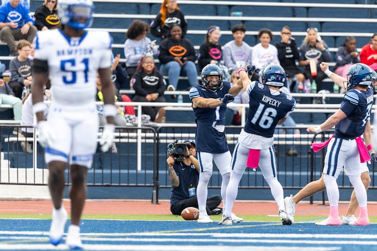 Wide receiver Luke Colella (1) and quarterback Pat McQuaide (far right) have formed instant chemistry since transferring into Villanova.