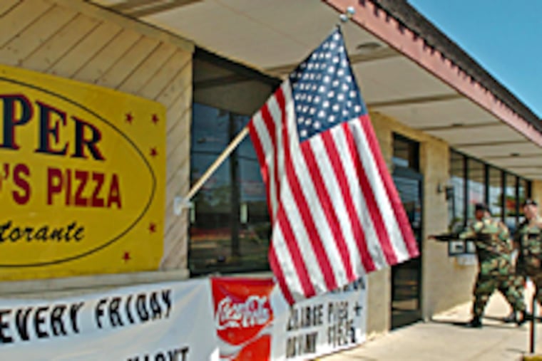 Two members of the military walking into Super Mario's Pizza Ristorante in
Cookstown, N.J., for lunch on Tuesday